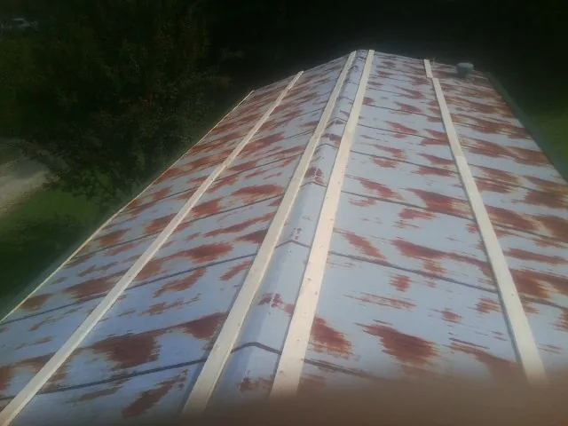 Rusted metal roof panels with new wood purlins before replacement — Storm Damage Roof Repair in Haddam by Roofing Brothers