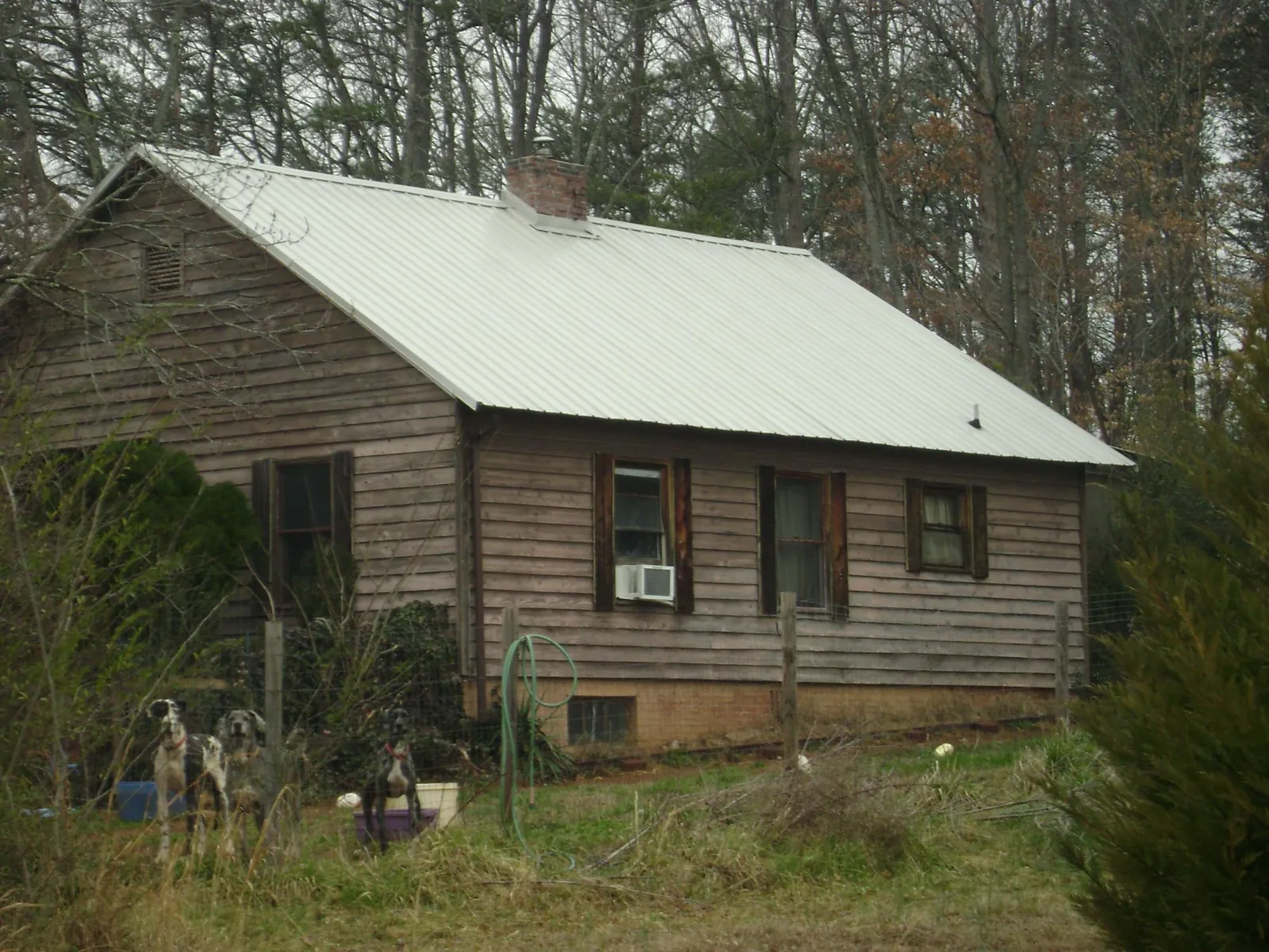 White metal roof on an old wood sided farmhouse, from a Metal Roof Installation job in Haddam